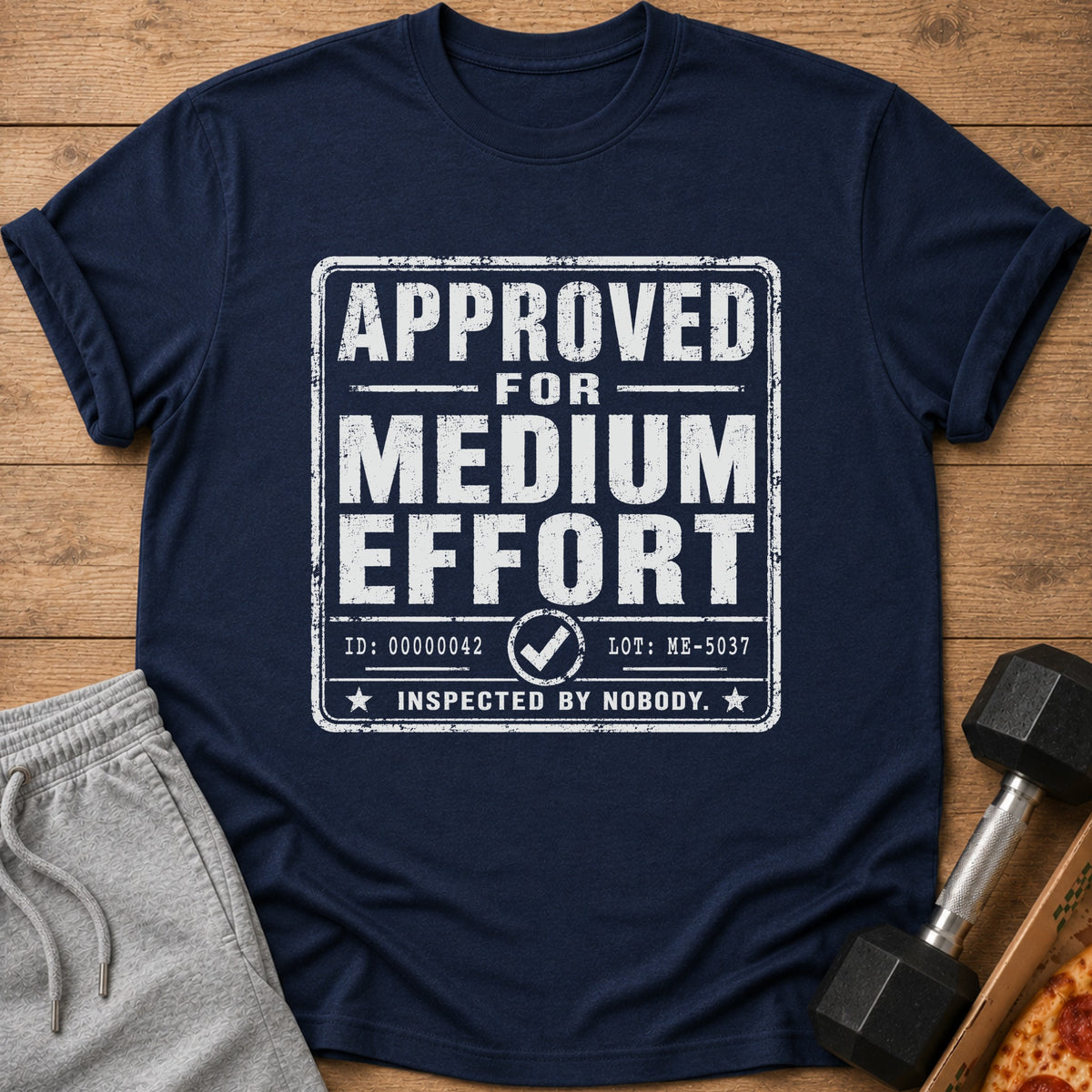 Navy t-shirt with "APPROVED FOR MEDIUM EFFORT INSPECTED BY NOBODY." text.