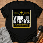 Black t-shirt with "Workout In Progress Low Battery" text and workout accessories.