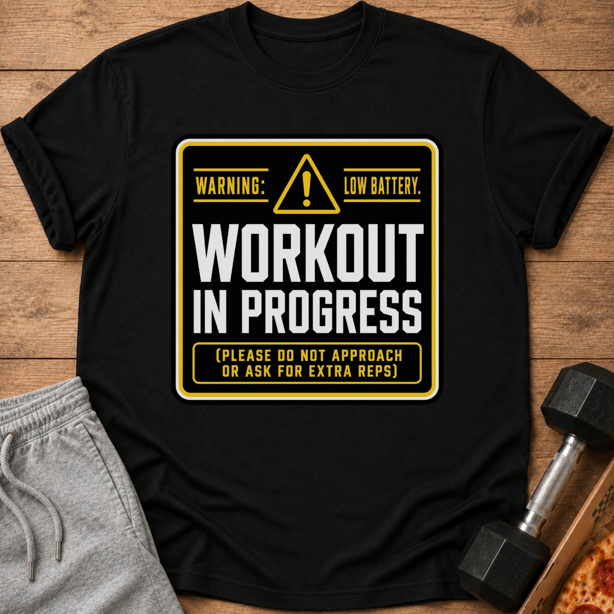 Black t-shirt with "Workout In Progress Low Battery" text and workout accessories.