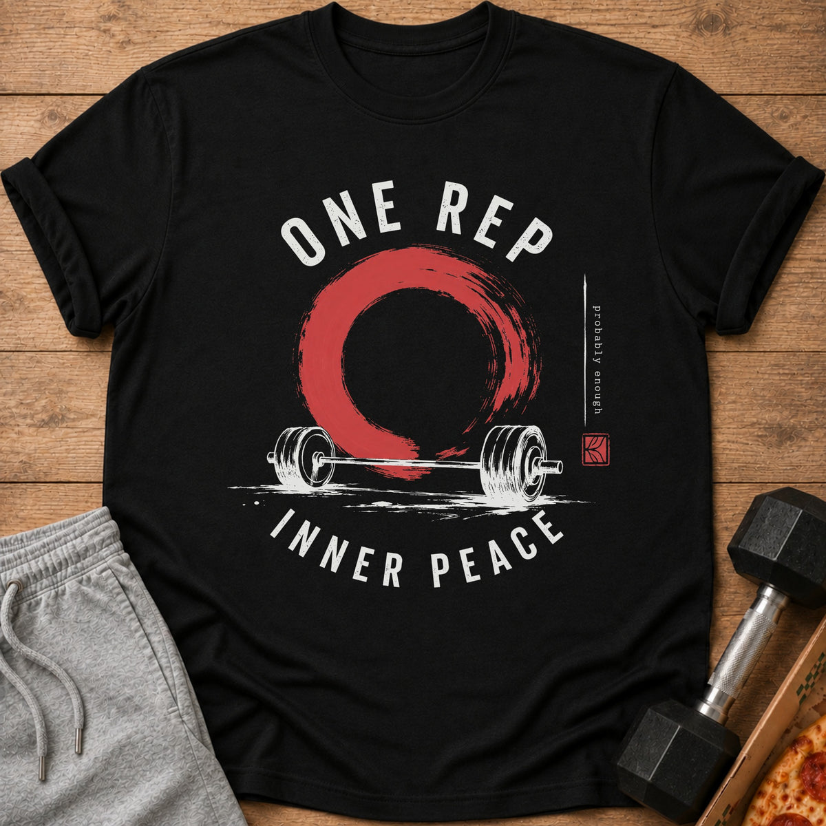 Black t-shirt with barbell, red circle, and "ONE REP INNER PEACE" text.