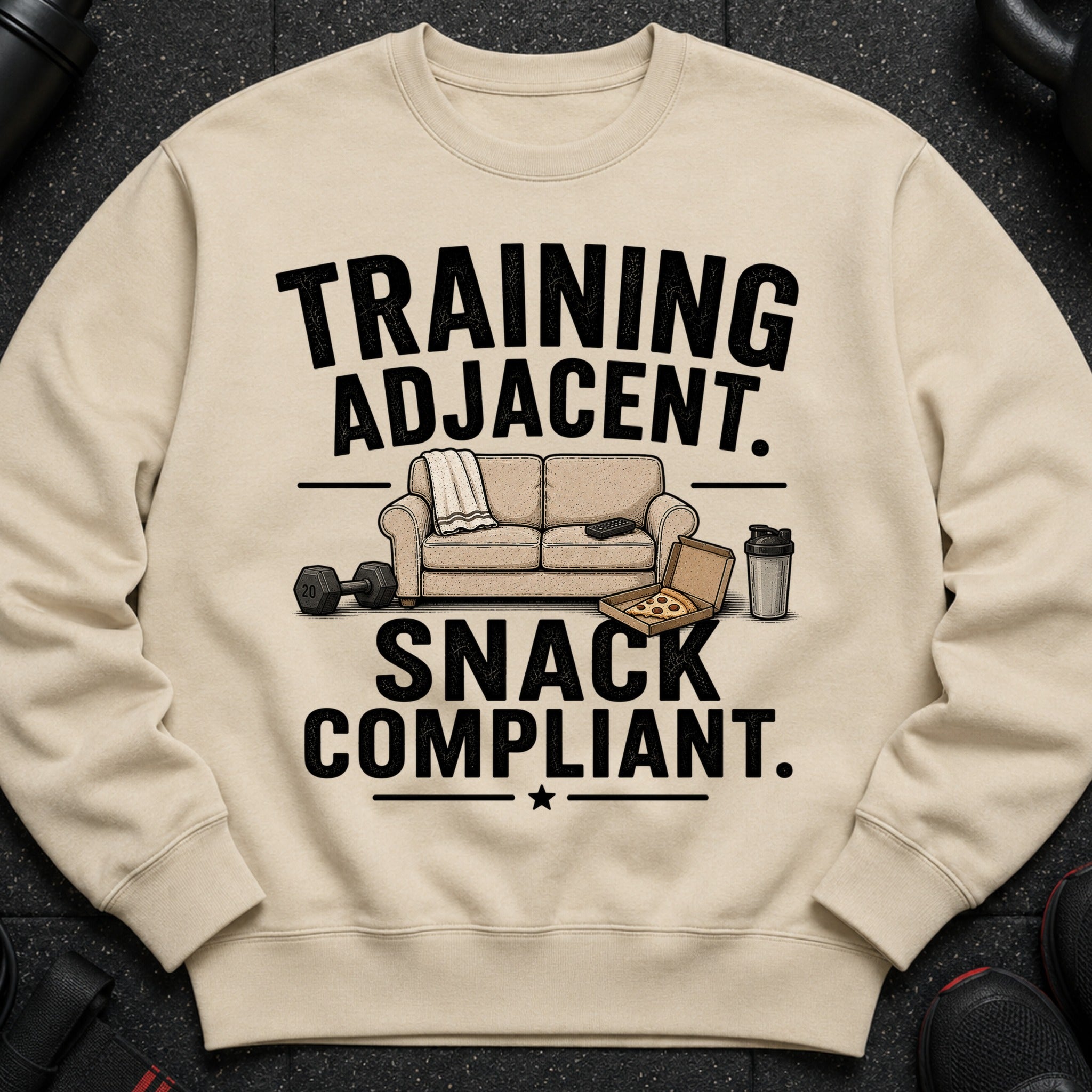 Sweatshirt with "Training Adjacent. Snack Compliant." text, couch, pizza, dumbbell, and shaker.