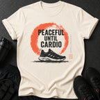 Light beige t-shirt with black text "PEACEFUL UNTIL CARDIO" over a red circle and a running shoe.