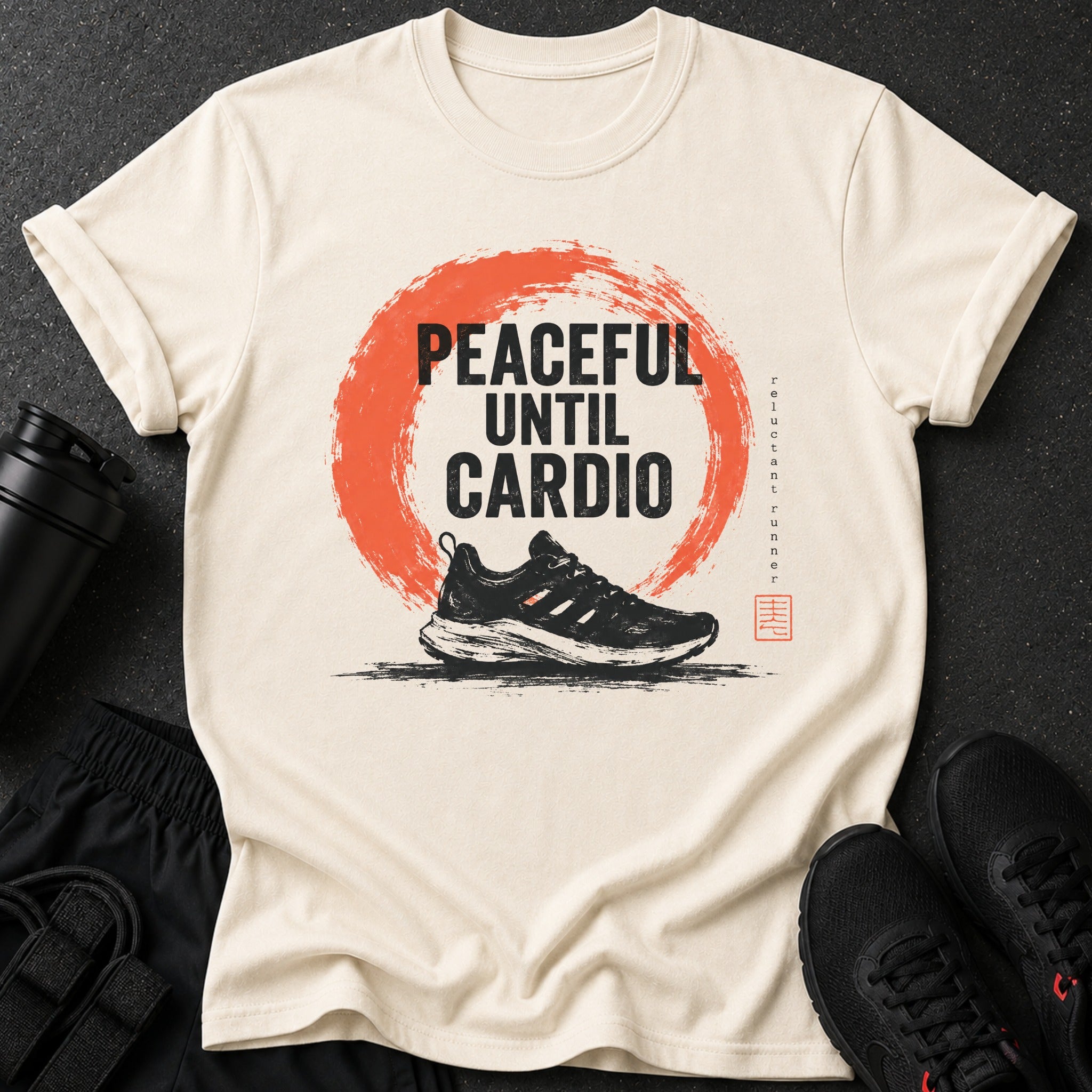 Light beige t-shirt with black text "PEACEFUL UNTIL CARDIO" over a red circle and a running shoe.