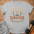 Grey t-shirt with "Leg Day Survivor" text and a pug lifting weights graphic.