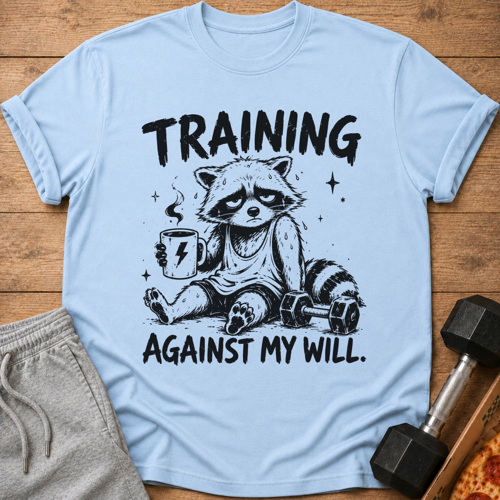 Light blue t-shirt with graphic of tired raccoon drinking coffee and text "TRAINING AGAINST MY WILL."