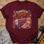 Maroon t-shirt with a graphic of autumn leaves, a coffee cup, dumbbells, and running shoes.
