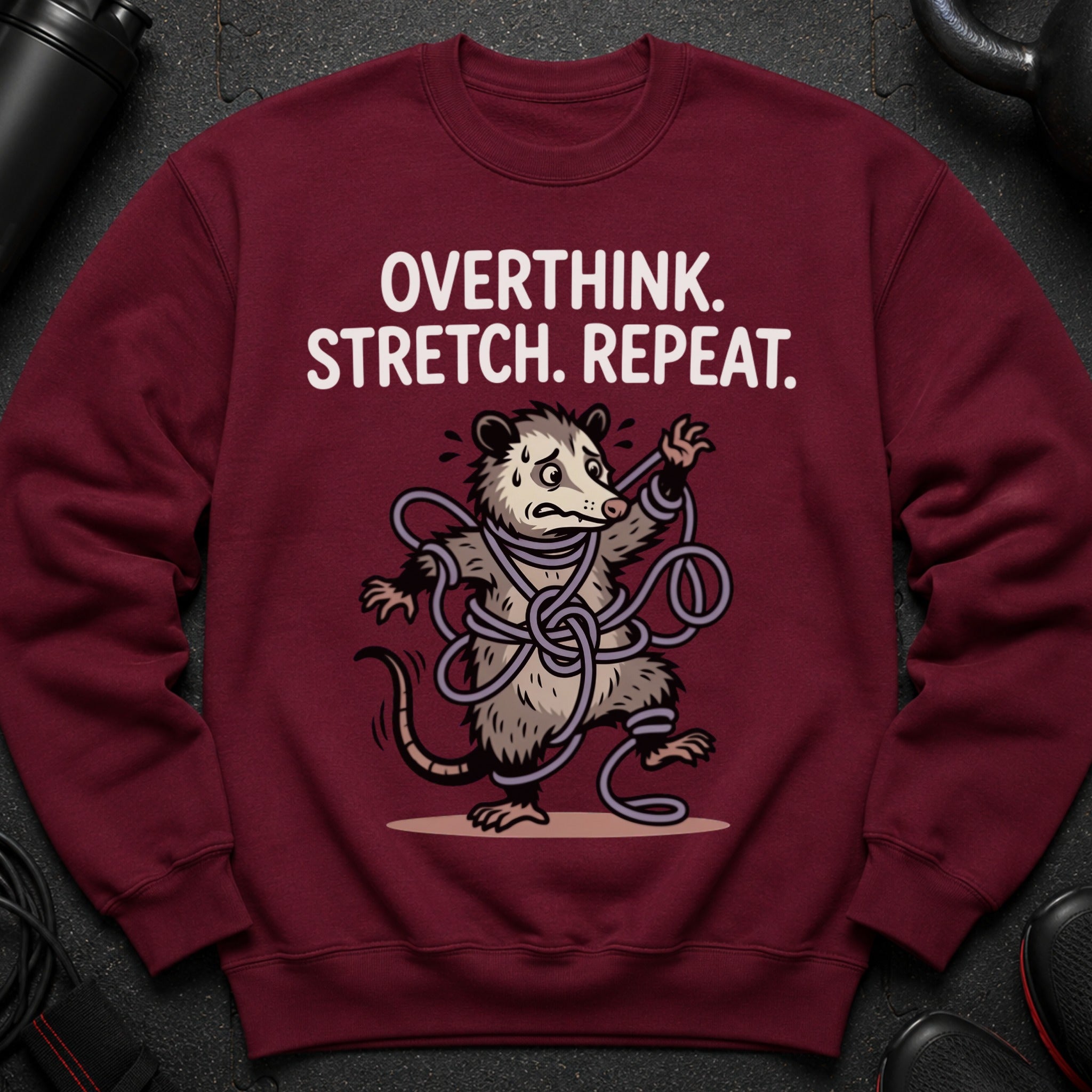 Maroon sweatshirt with a tangled opossum graphic and text that reads "OVERTHINK. STRETCH. REPEAT."