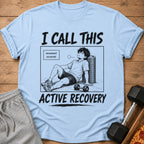 Light blue t-shirt with a manga-style graphic of a tired man and text.