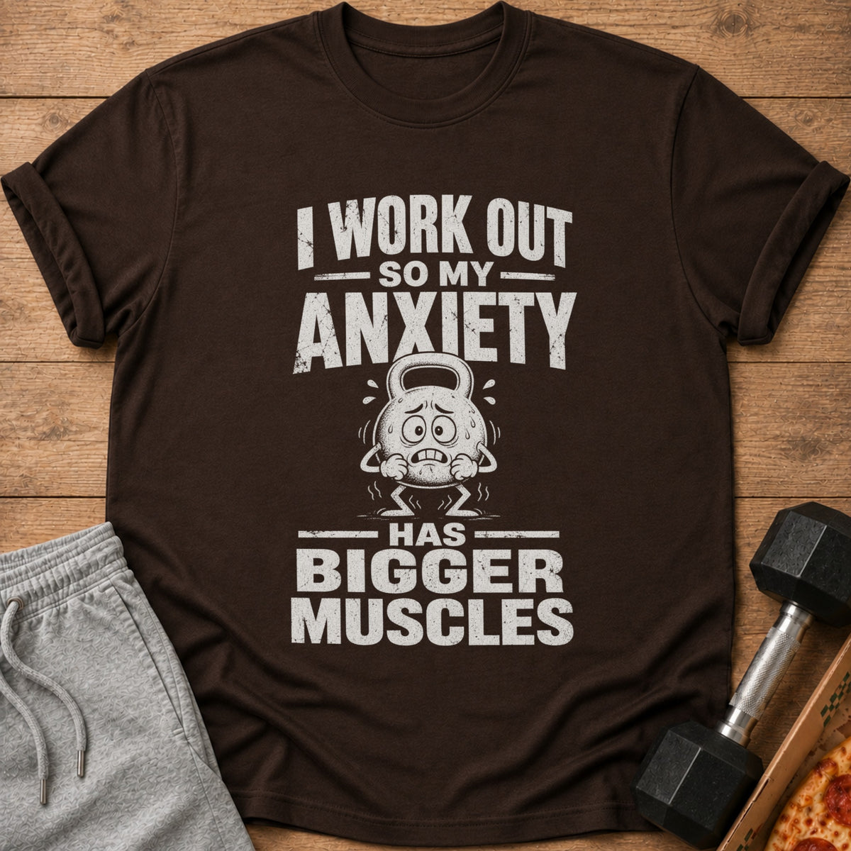 Brown t-shirt with text "I WORK OUT SO MY ANXIETY HAS BIGGER MUSCLES".