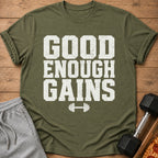 Green t-shirt with white text "GOOD ENOUGH GAINS" and dumbbell graphic.