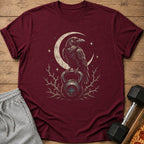 Maroon t-shirt with crow on kettlebell and crescent moon graphic.