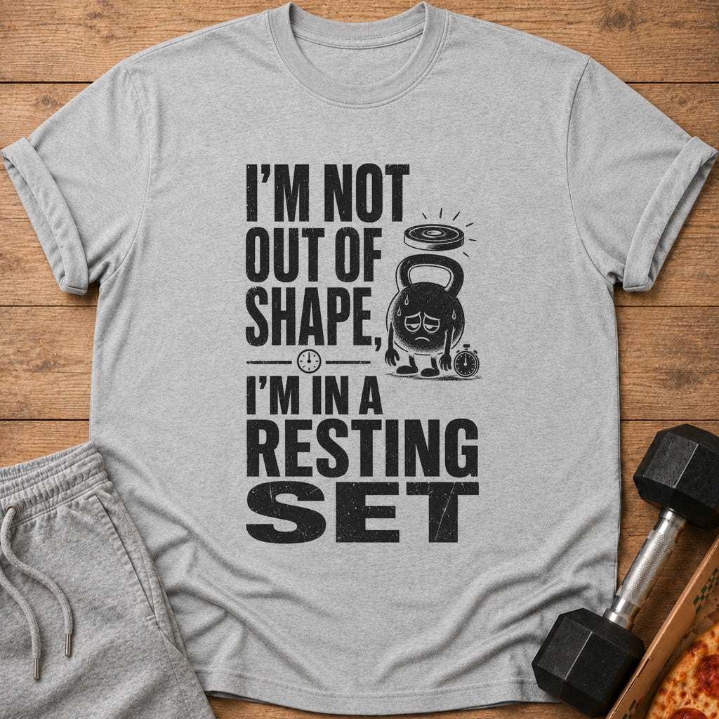 Grey t-shirt with black text "I'M NOT OUT OF SHAPE, I'M IN A RESTING SET" and cartoon kettlebell.