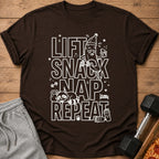 Brown t-shirt with "Lift Snack Nap Repeat" graphic, a tired banana, and a sleeping raccoon.