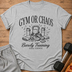 Grey t-shirt with "Gym or Chaos Barely Training Still Counts" graphic.