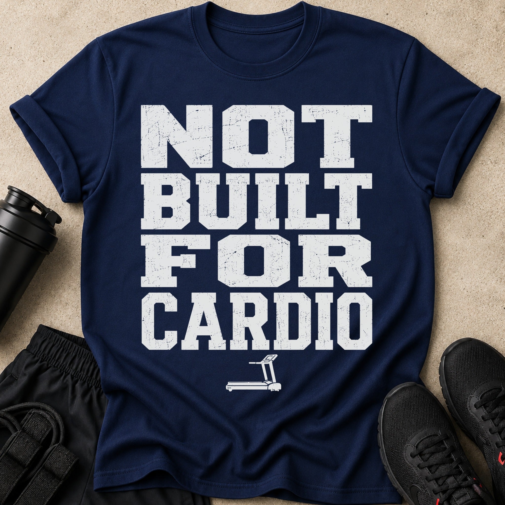 Navy t-shirt with distressed white text reading "NOT BUILT FOR CARDIO" and a treadmill icon.