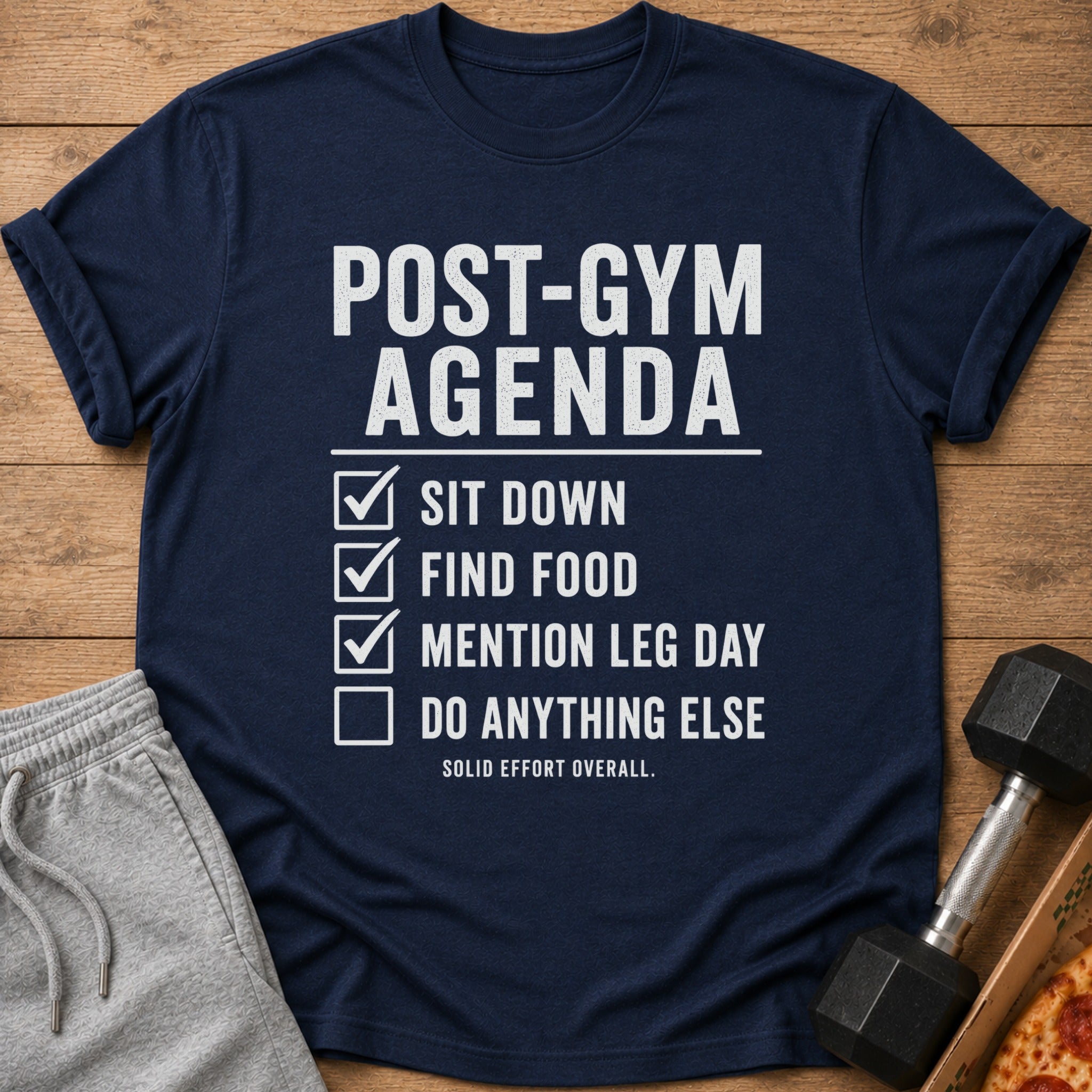Navy t-shirt with "Post-Gym Agenda" checklist: sit down, find food, mention leg day.