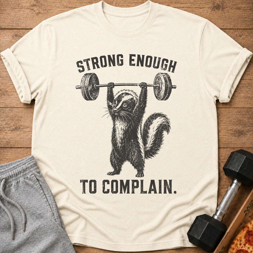 T-shirt with skunk lifting barbell and text "STRONG ENOUGH TO COMPLAIN."