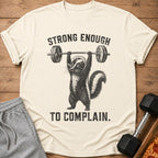 T-shirt with skunk lifting barbell and text "STRONG ENOUGH TO COMPLAIN."