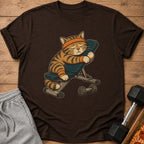 Tired tabby cat with orange headband and wristbands rests on weight bench with dumbbell.