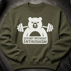 Olive green sweatshirt with white grumpy bear lifting weights graphic.