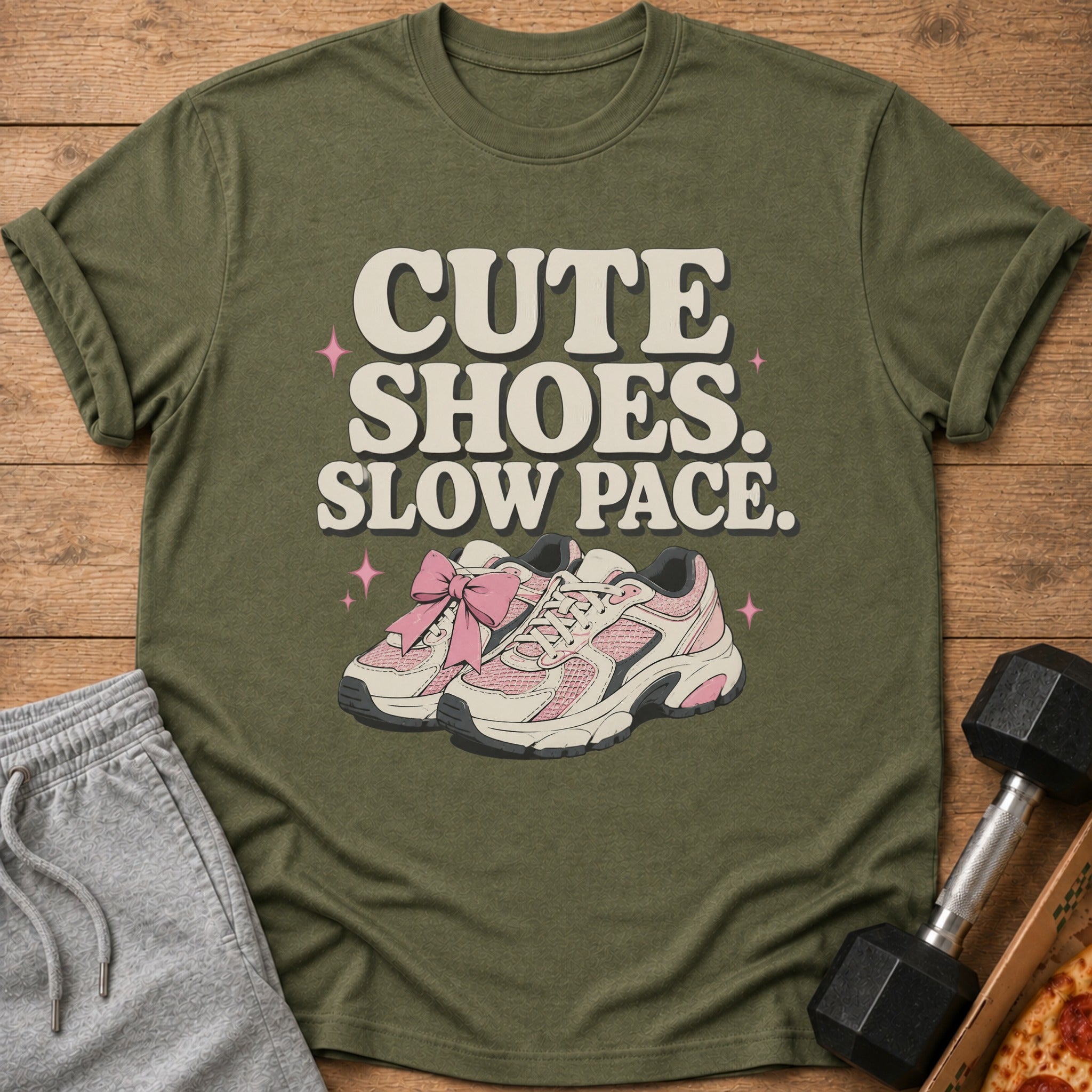 Olive green t-shirt with "CUTE SHOES. SLOW PACE." text and pink shoes graphic.