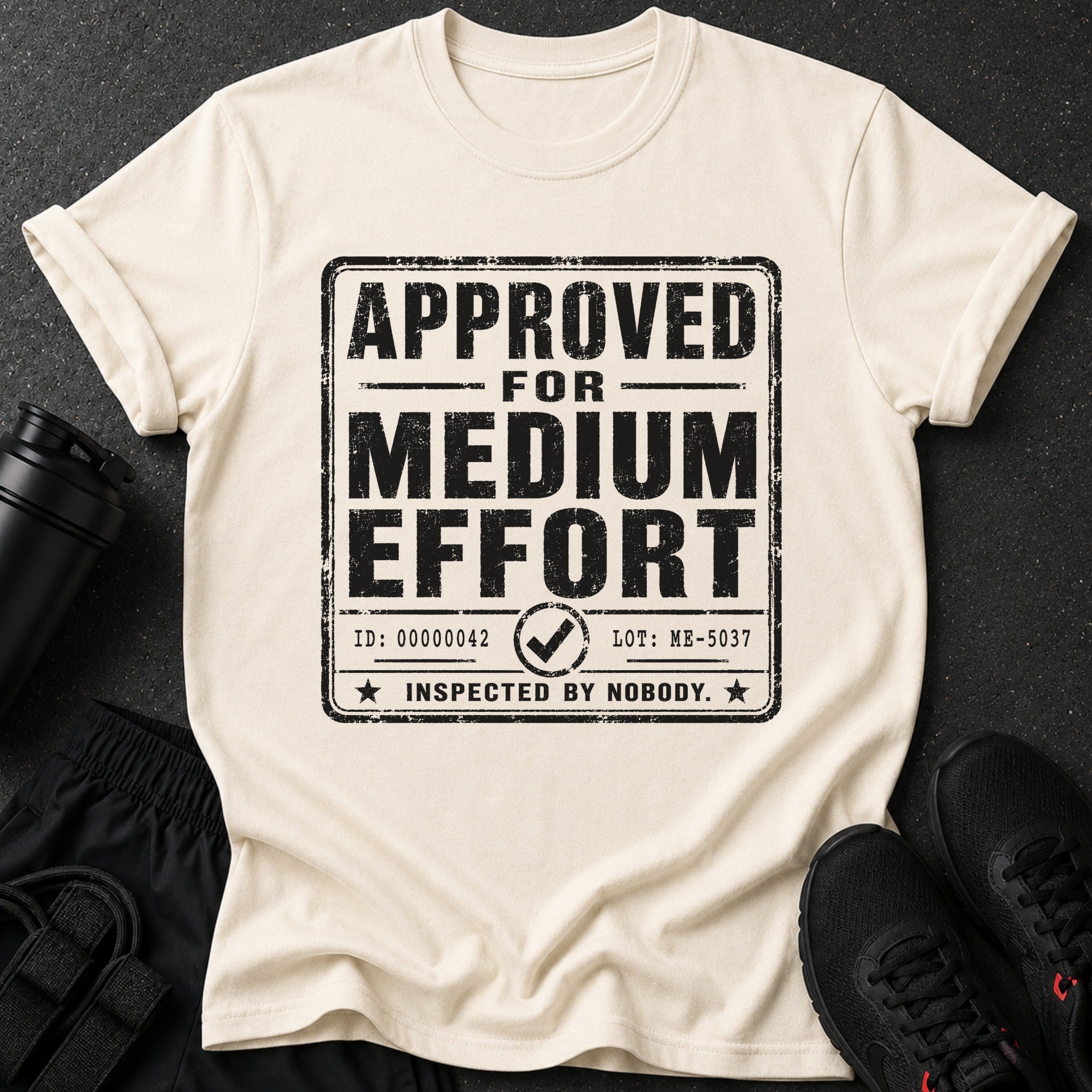 Cream t-shirt with black text "APPROVED FOR MEDIUM EFFORT INSPECTED BY NOBODY".