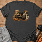 Three puppies pose on a dumbbell with a pumpkin and fall leaves.