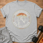 Grey t-shirt with "Professional Gym Influencer (Unpaid)" graphic and retro sunset mountain scene.