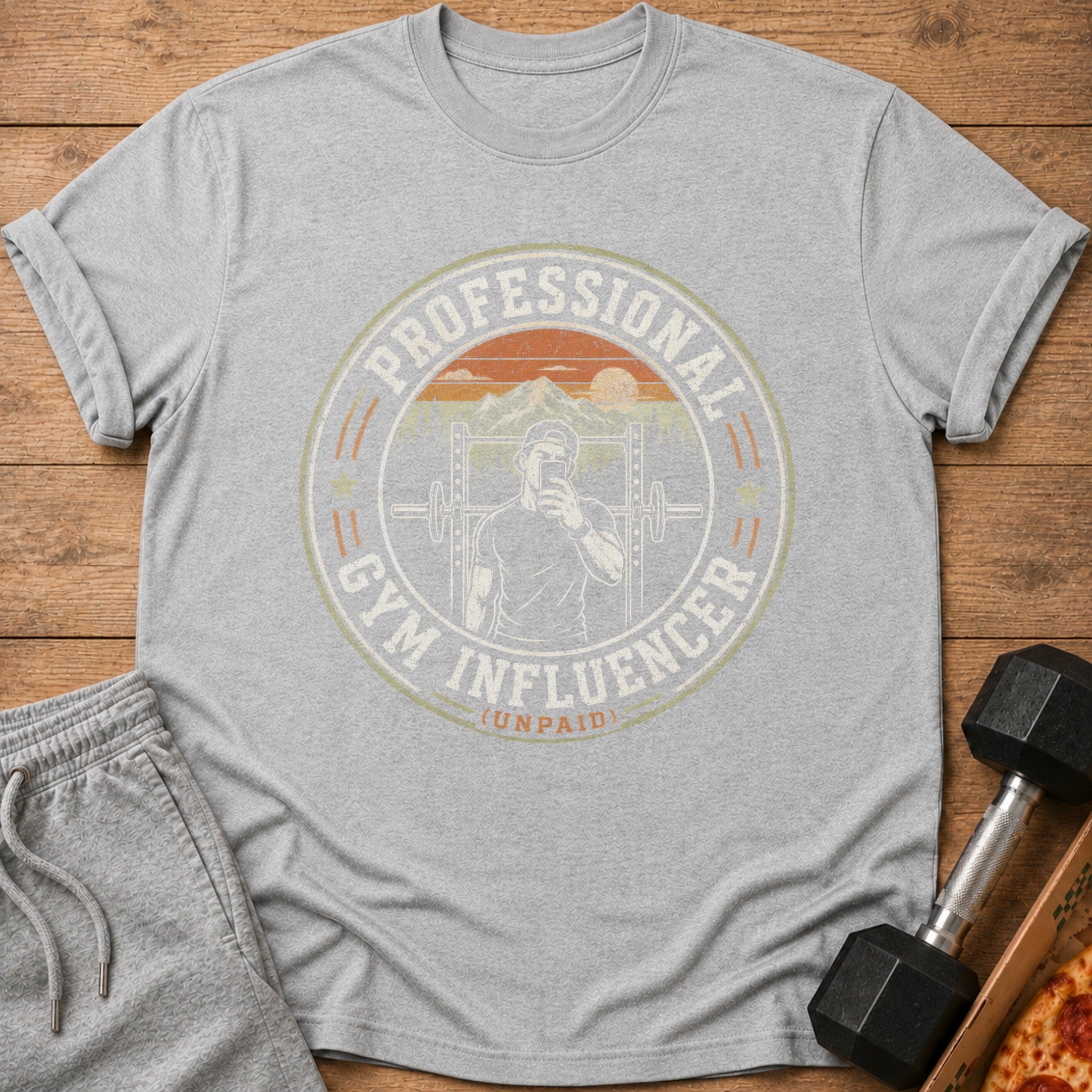 Grey t-shirt with "Professional Gym Influencer (Unpaid)" graphic and retro sunset mountain scene.