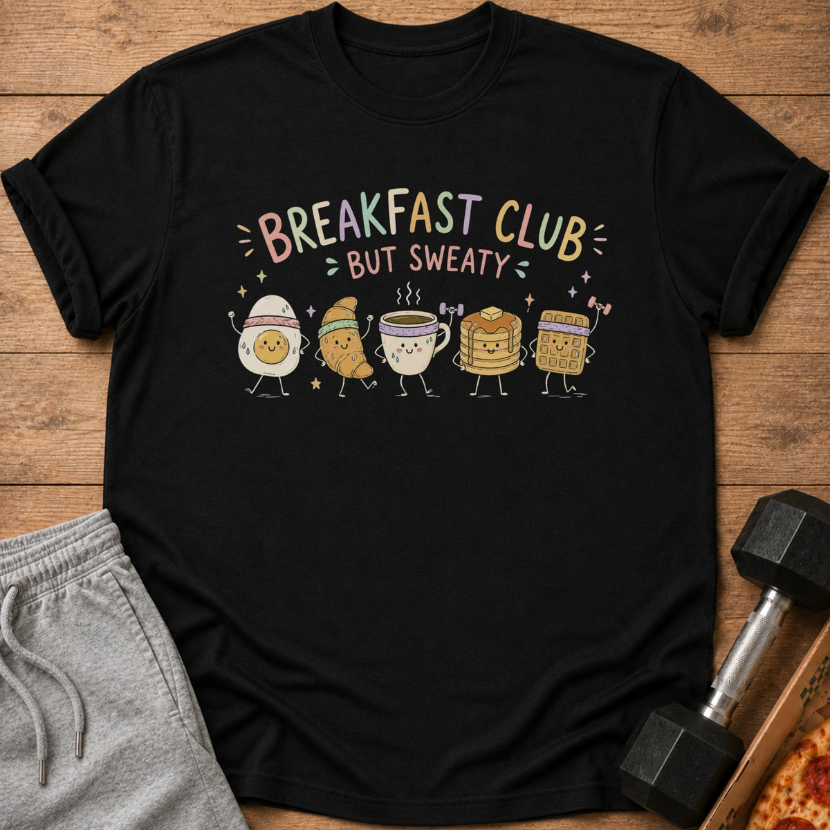 Black t-shirt with "Breakfast Club But Sweaty" text and cartoon breakfast foods exercising.