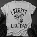 Grey t-shirt with a flamingo holding a kettlebell and text "I REGRET LEG DAY".