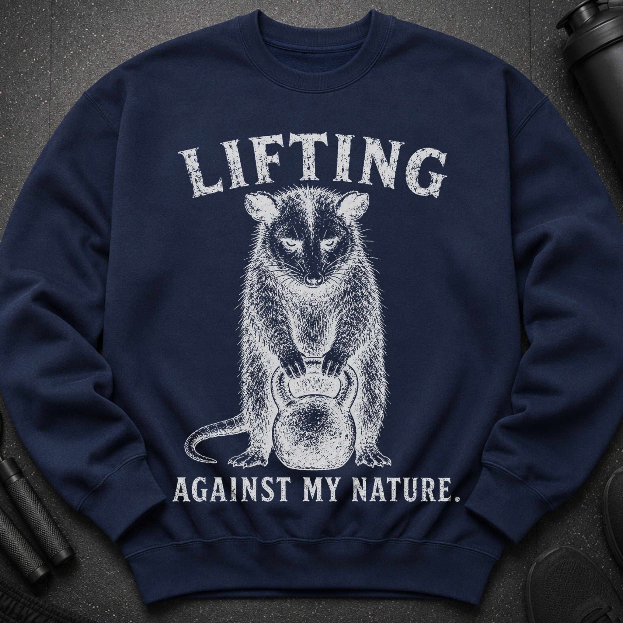 Navy sweatshirt with distressed graphic of animal lifting kettlebell and text.