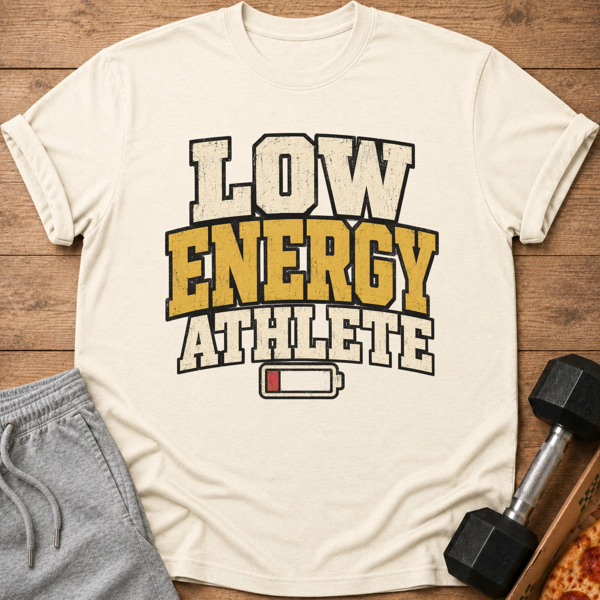 Cream t-shirt with "Low Energy Athlete" text and a low battery symbol.
