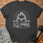 T-shirt with graphic of person in hoodie sitting on bench with gym bag.