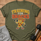 Olive green t-shirt with cartoon pizza lifting dumbbells and text "Training for Snacks."