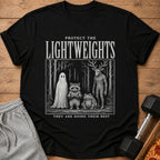 Black t-shirt with "Protect the Lightweights" and forest creatures including a ghost, raccoon, frog, and deer-like figure.