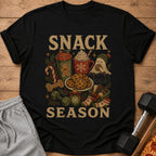 Black t-shirt with "SNACK SEASON" text and festive holiday and gym imagery.