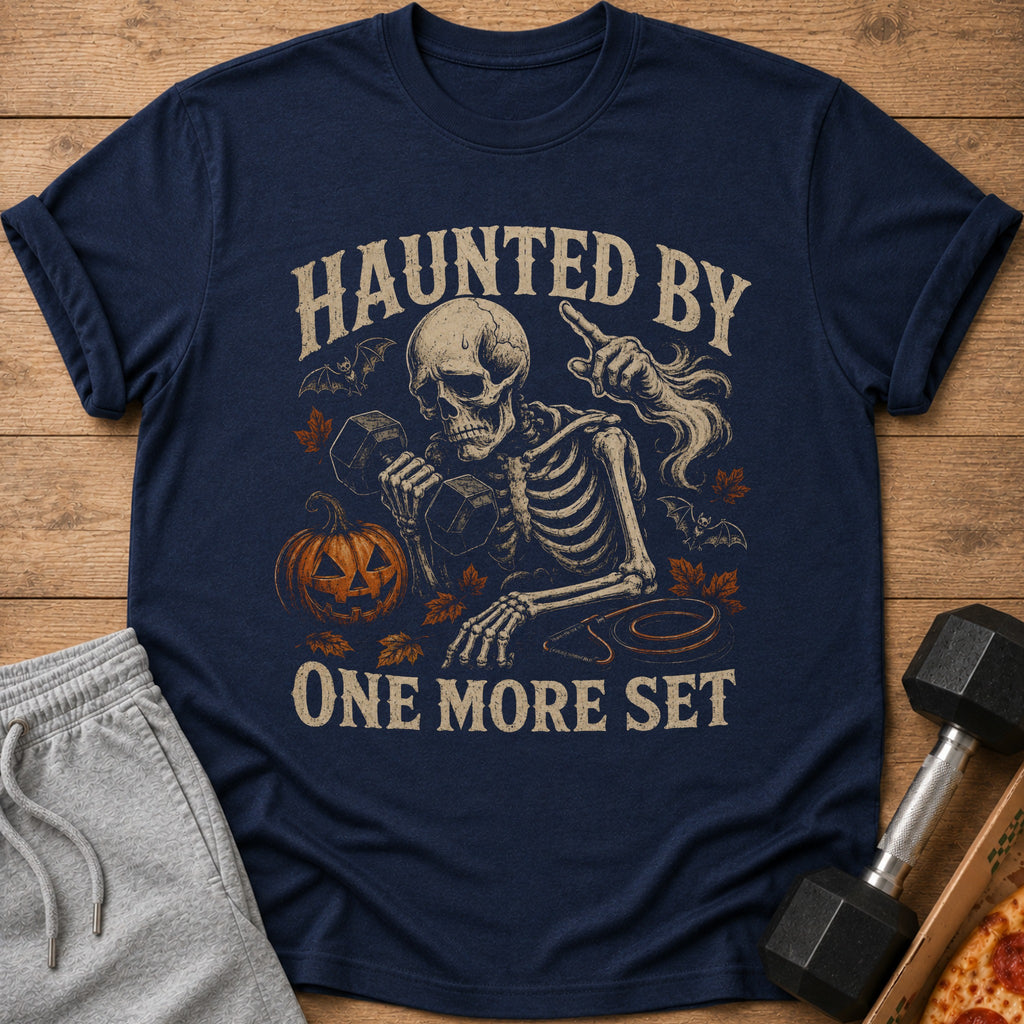Skeleton lifting weights with text "Haunted By One More Set" and Halloween graphics.