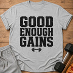 Grey t-shirt with black text "GOOD ENOUGH GAINS" and a barbell icon.