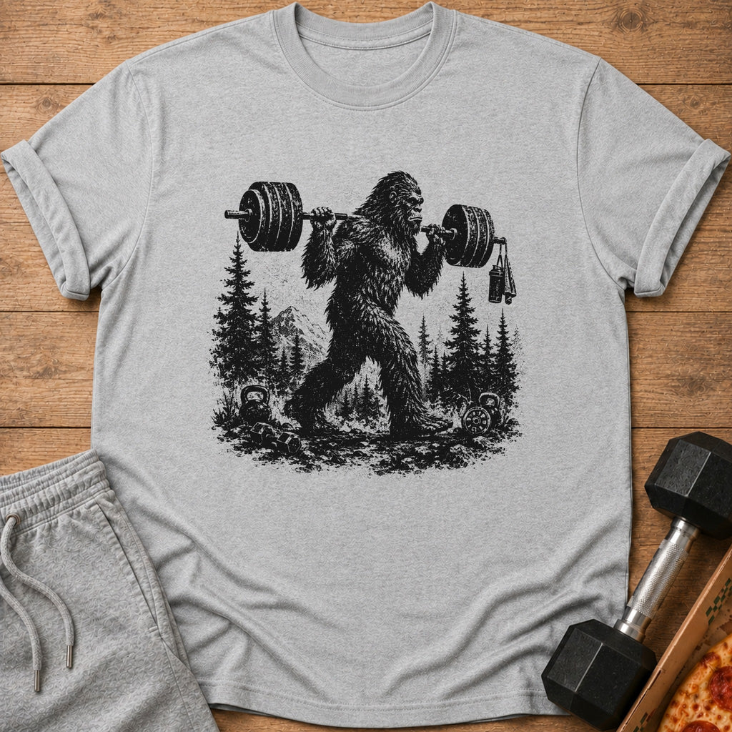 Bigfoot lifting a barbell with weights and a towel in a forest setting.