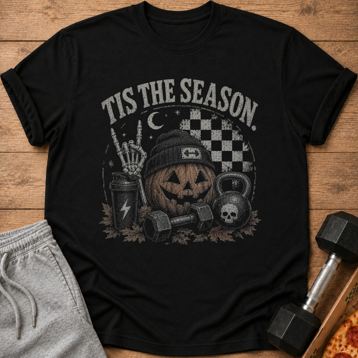 Black t-shirt with Halloween fitness graphic: "Tis the Season", pumpkin, dumbbells, kettlebell.