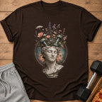 Brown t-shirt featuring a classical bust with dumbbells and flowers growing from its head.
