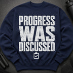 Navy sweatshirt with white distressed text that reads "PROGRESS WAS DISCUSSED" and a clipboard icon.