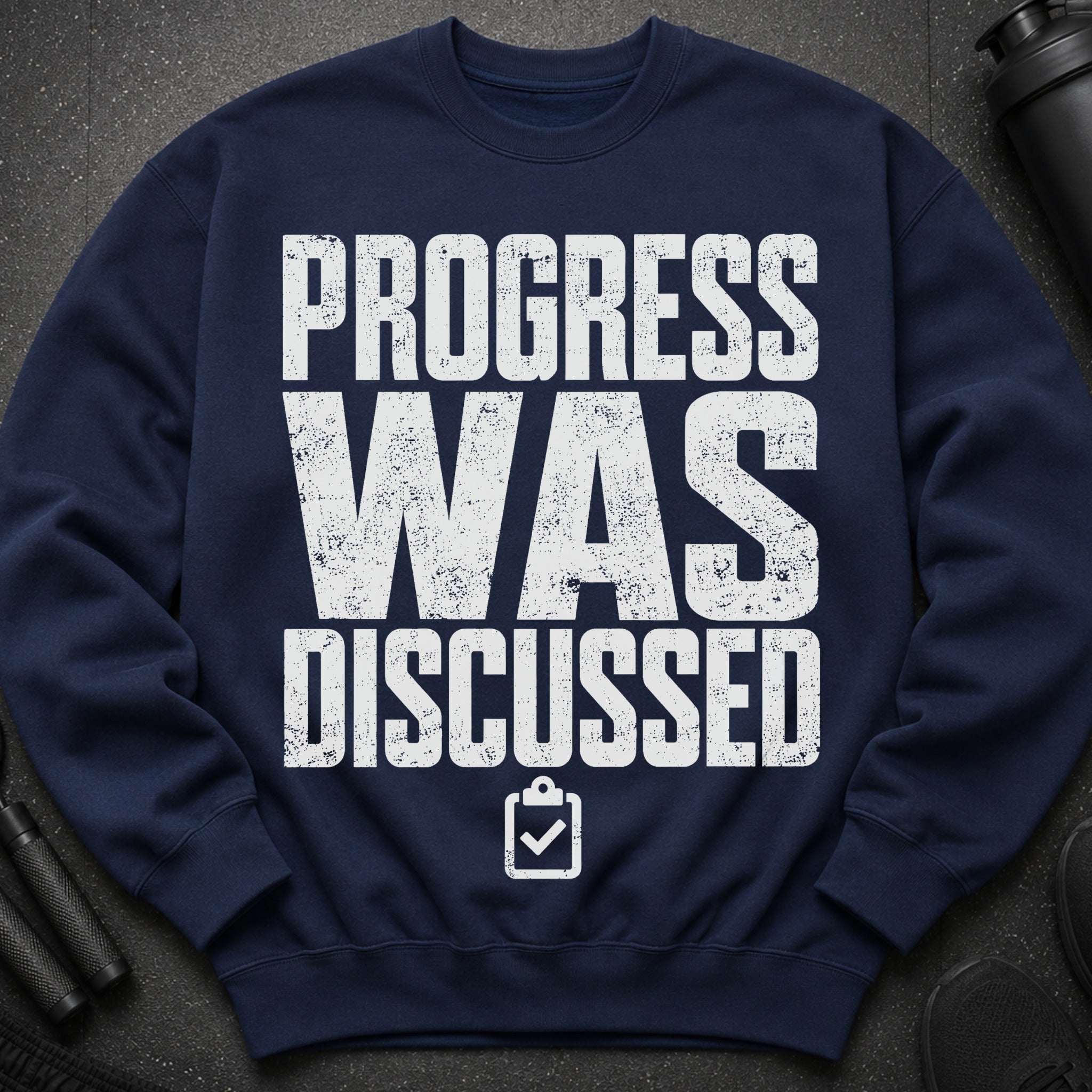 Navy sweatshirt with white distressed text that reads "PROGRESS WAS DISCUSSED" and a clipboard icon.