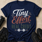 Navy t-shirt with "Tiny Effort, Real Credit" text and dumbbell graphic.