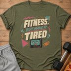 Green t-shirt with "FITNESS, BUT MAKE IT TIRED" text and tired TV graphic.