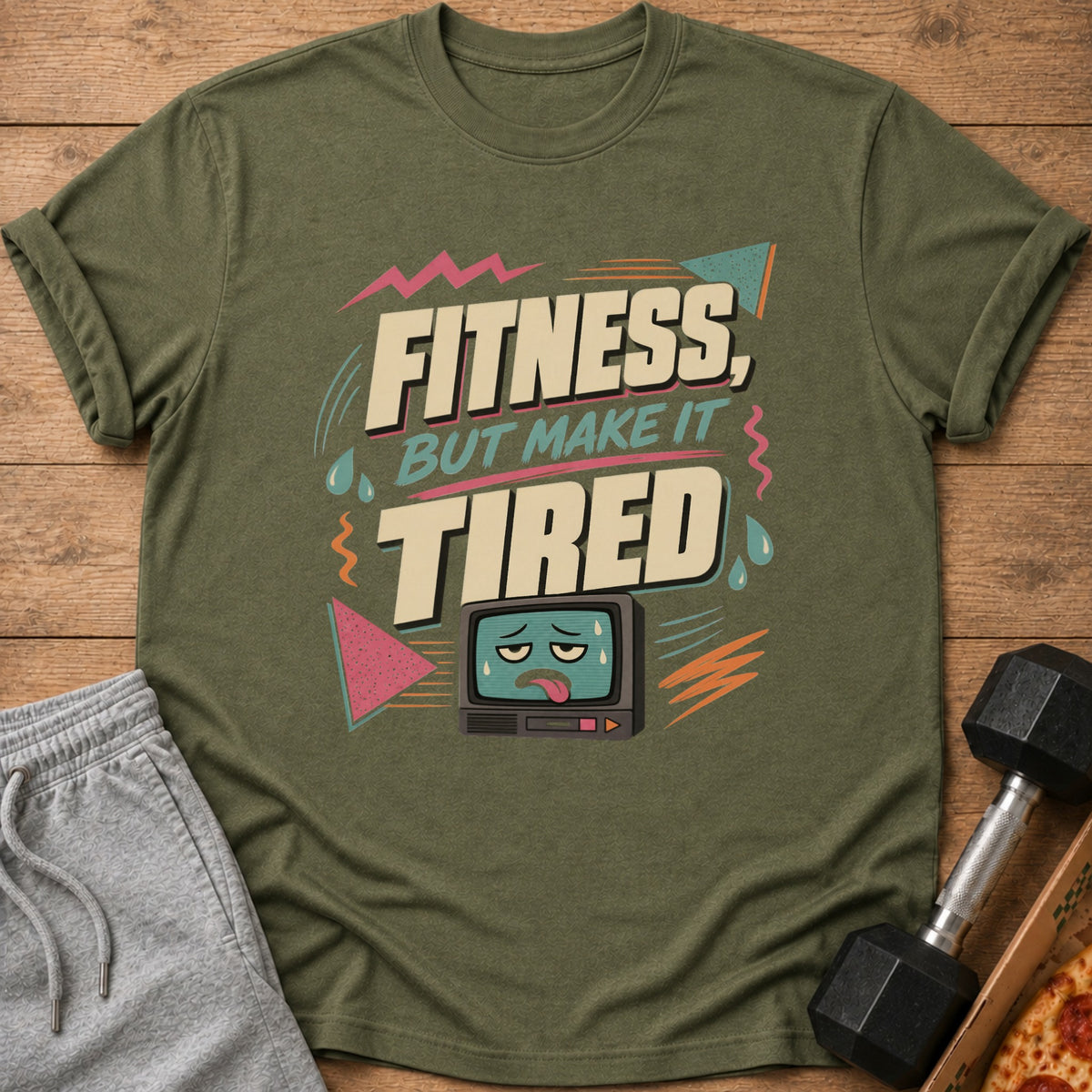 Green t-shirt with "FITNESS, BUT MAKE IT TIRED" text and tired TV graphic.