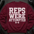 Maroon sweatshirt with graphic text "REPS WERE ATTEMPTED" and barbell.