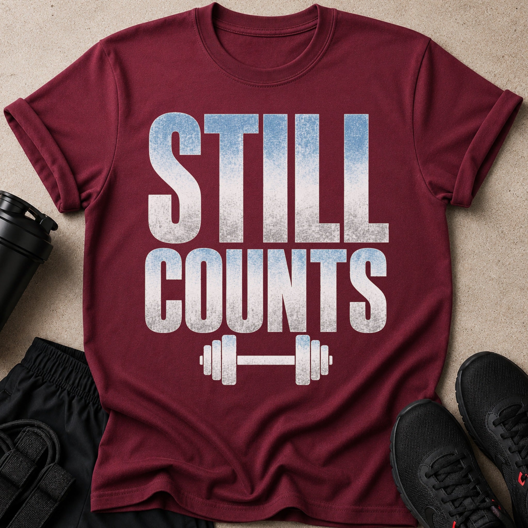 Burgundy t-shirt with white distressed text and barbell graphic.