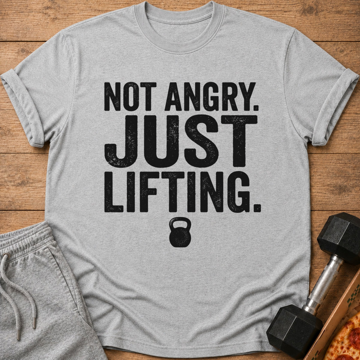 Grey t-shirt with black text "NOT ANGRY. JUST LIFTING." and a kettlebell icon.